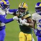 This Jan. 16, 2021, file photo shows Green Bay Packers&#x27; Aaron Jones (33) being chased down by Los Angeles Rams&#x27; Jordan Fuller (32) and Rams&#x27; Darious Williams during the second half of an NFL divisional playoff football game in Green Bay, Wis. The Pro Bowl running back, Jones has agreed to a new deal with the Green Bay Packers and won’t be exploring free agency. Drew Rosenhaus, Jones’ agent, confirmed that his client had agreed on a four-year deal worth $48 million that includes a $13 million signing bonus. (AP Photo/Matt Ludtke, File) **FILE**