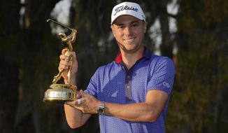 Justin Thomas holds the trophy after winning The Players Championship golf tournament Sunday, March 14, 2021, in Ponte Vedra Beach, Fla.(AP Photo/John Raoux)