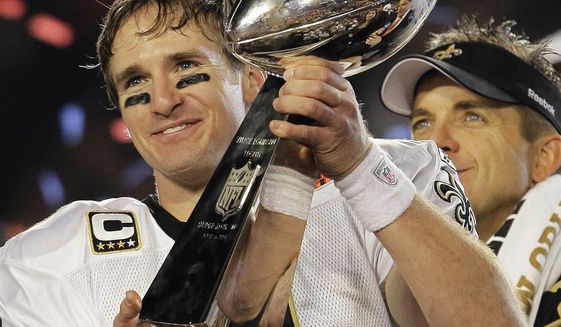 File-This Feb. 7, 2010, file photo shows New Orleans Saints quarterback Drew Brees (9) celebrating with the Vince Lombardi Trophy after the Saints&#39; 31-17 win over the Indianapolis Colts in the NFL Super Bowl XLIV football game in Miami. Brees, the NFL’s leader in career completions and yards passing, has decided to retire after 20 NFL seasons, including his last 15 with New Orleans. (AP Photo/Julie Jacobson, File)