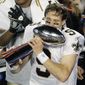 File-This Feb. 7, 2010, file photo shows New Orleans Saints quarterback Drew Brees (9) celebrating with the Vince Lombardi Trophy after the NFL Super Bowl XLIV football game against the Indianapolis Colts in Miami. Brees, the NFL’s leader in career completions and yards passing has decided to retire after 20 NFL seasons, including his last 15 with New Orleans. (AP Photo/Charlie Riedel, File)