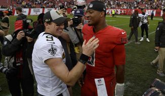 FILE - In this Dec. 9, 2018, file photo, New Orleans Saints quarterback Drew Brees (9) shakes hands with Tampa Bay Buccaneers quarterback Jameis Winston (3) after an NFL football game in Tampa, Fla.  Brees, the NFL’s leader in career completions and yards passing, has decided to retire after 20 NFL seasons, including his last 15 with New Orleans.(AP Photo/Jason Behnken, File)