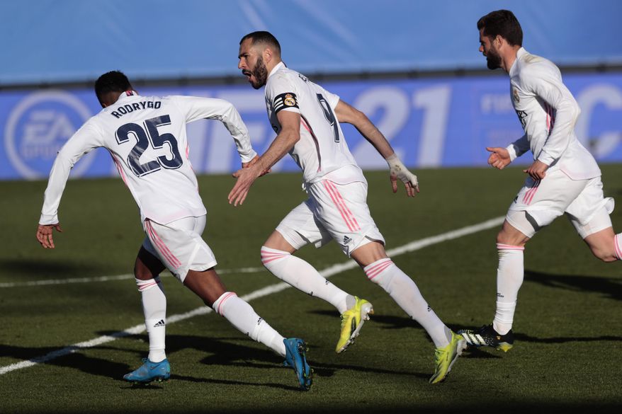 Real Madrid's Karim Benzema celebrates scoring his side's first goal during the Spanish La Liga soccer match between Real Madrid and Elche at the Alfredo di Stefano stadium in Madrid, Spain, Saturday, March 13, 2021. (AP Photo/Bernat Armangue)
