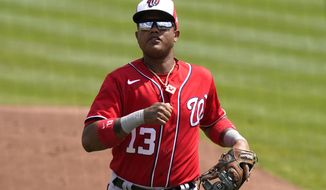 Washington Nationals&#39; Starlin Castro (13) goes to the dugout during a spring training baseball game against the St. Louis Cardinals, Monday, March 15, 2021, in Jupiter, Fla. (AP Photo/Lynne Sladky)
