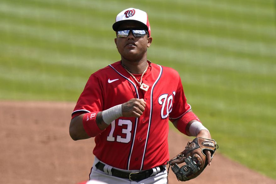Washington Nationals&#39; Starlin Castro (13) goes to the dugout during a spring training baseball game against the St. Louis Cardinals, Monday, March 15, 2021, in Jupiter, Fla. (AP Photo/Lynne Sladky)