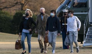 President Joe Biden and first lady Jill Biden with their grandson Hunter Biden, walk on the South Lawn upon arrival at the White House in Washington from a weekend trip to Wilmington, Del., Sunday, March 14, 2021. (AP Photo/Manuel Balce Ceneta)