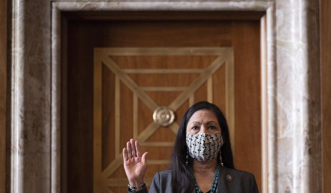 FILE - In this Feb. 23, 2021, file photo, Rep. Deb Haaland, D-N.M., is sworn in before the Senate Committee on Energy and Natural Resources hearing on her nomination to be Interior Secretary on Capitol Hill in Washington. (Jim Watson/Pool via AP, File}