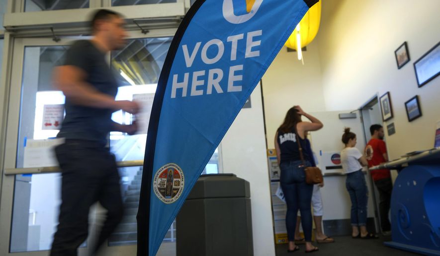 FILE - In this March 3, 2020 file photo, voters wait in line to cast their ballot on Super Tuesday, at a voting center in El Segundo, Calif. California's Democratic-controlled state Legislature is considering making it more difficult for local election officials to disqualify ballots. (AP Photo/Ringo H.W. Chiu, File)
