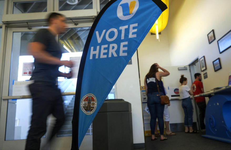 FILE - In this March 3, 2020 file photo, voters wait in line to cast their ballot on Super Tuesday, at a voting center in El Segundo, Calif. California's Democratic-controlled state Legislature is considering making it more difficult for local election officials to disqualify ballots. (AP Photo/Ringo H.W. Chiu, File)