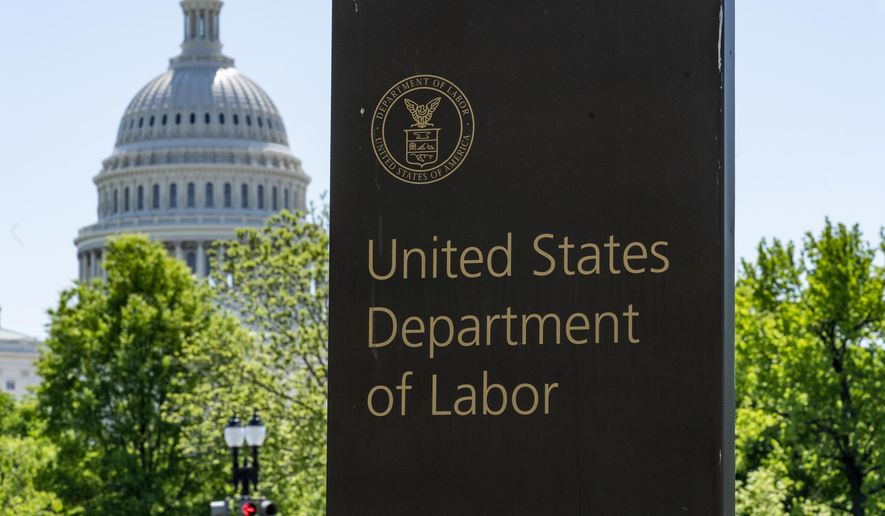 In this May 7, 2020, photo, the entrance to the Labor Department is seen near the Capitol in Washington. Unemployment fraud in the U.S. has reached dramatic levels during the pandemic: more than $63 billion has been paid out improperly through fraud or errors since March 2020. Criminals are seizing on the opportunity created by the pandemic and are making false claims using stolen information. (AP Photo/J. Scott Applewhite) **FILE**