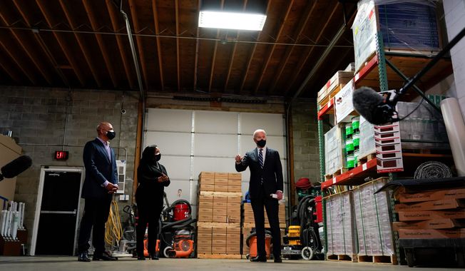 President Biden toured Smith Flooring Inc. in Chester, Pennsylvania, on Tuesday and met with owners Kristen and James Smith. Smith Flooring was one of the businesses that received a Paycheck Protection Program loan last year. Mr. Biden said the PPP program needs more oversight. (Associated Press)