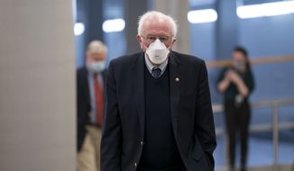 Sen. Bernie Sanders, I-Vt., chairman of the Senate Budget Committee, arrives as the Senate holds votes on nominees for the Biden administration, at the Capitol in Washington, Tuesday, March 16, 2021. (AP Photo/J. Scott Applewhite)