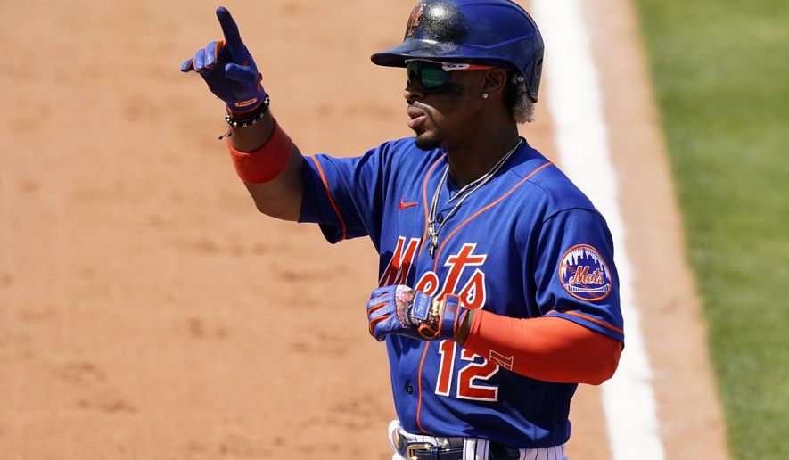 New York Mets' Francisco Lindor (12) reacts after hitting a two-run home run during the sixth inning of a spring training baseball game against the Houston Astros, Tuesday, March 16, 2021, in Port St. Lucie, Fla. (AP Photo/Lynne Sladky)