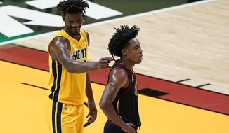 Miami Heat forward Jimmy Butler, rear, plays with Cleveland Cavaliers guard Collin Sexton&#39;s hair during the second half of an NBA basketball game Tuesday, March 16, 2021, in Miami. (AP Photo/Wilfredo Lee)