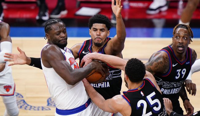 New York Knicks&#x27; Julius Randle, from left, battles for the ball against Philadelphia 76ers&#x27; Danny Green, Ben Simmons and Dwight Howard during the first half of an NBA basketball game, Tuesday, March 16, 2021, in Philadelphia. (AP Photo/Matt Slocum)