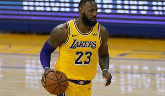 Los Angeles Lakers forward LeBron James (23) dribbles the ball up the court against the Golden State Warriors during the first half of an NBA basketball game in San Francisco, Monday, March 15, 2021. (AP Photo/Jeff Chiu)
