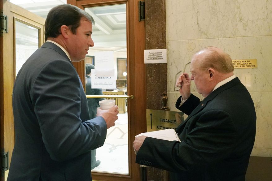 Mississippi Senate Finance Committee Chairman Josh Harkins, left, a Republican from Flowood, reviews a number of proposed bills with Senate Accountability Efficiency and Transparency Committee Chairman John Polk, R-Hattiesburg, earlier this session, March 2, 2021, at the Capitol in Jackson, Miss. Harkins says he wants to see a thorough evaluation of a House bill that would make significant changes in the state tax structure. The bill is facing a deadline for Senate action on Tuesday, March 16, 2021. (AP Photo/Rogelio V. Solis)