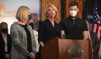 Omaha Mayor Jean Stothert, accompanied by her children Elizabeth Leddy and Dr. Andrew Stothert, speaks during a press conference, Tuesday, March 16, 2021, in Omaha, Neb. Stothert made her first public appearance Tuesday and confirmed that she&#39;ll return to work and seek re-election after her husband, a prominent local surgeon, died earlier this month from a self-inflicted gunshot wound.  (Lily Smith/Omaha World-Herald via AP)