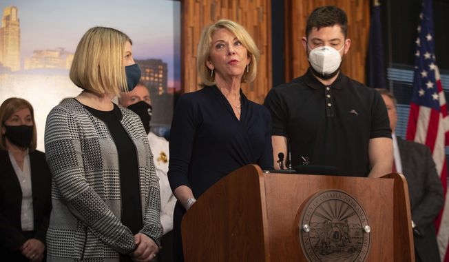 Omaha Mayor Jean Stothert, accompanied by her children Elizabeth Leddy and Dr. Andrew Stothert, speaks during a press conference, Tuesday, March 16, 2021, in Omaha, Neb. Stothert made her first public appearance Tuesday and confirmed that she&#x27;ll return to work and seek re-election after her husband, a prominent local surgeon, died earlier this month from a self-inflicted gunshot wound.  (Lily Smith/Omaha World-Herald via AP)