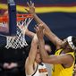 Indiana Pacers center Myles Turner, right, goes over Denver Nuggets forward Michael Porter Jr. for a rebound in the second half of an NBA basketball game Monday, March 15, 2021, in Denver. (AP Photo/David Zalubowski)