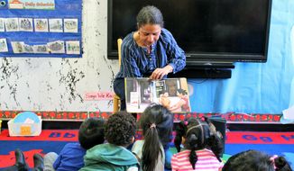 In this 2018 photo provided by Children&#39;s Aid, Nina Crews, illustrator of &amp;quot;A Girl Like Me,&amp;quot; reads to children at an early childhood education center.  Crews said the work of independent publishers and grassroots organizers are vital in bringing more racial diversity into children&#39;s books. (Adriana Alba/Children’s Aid via AP)