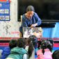 In this 2018 photo provided by Children&#39;s Aid, Nina Crews, illustrator of &amp;quot;A Girl Like Me,&amp;quot; reads to children at an early childhood education center.  Crews said the work of independent publishers and grassroots organizers are vital in bringing more racial diversity into children&#39;s books. (Adriana Alba/Children’s Aid via AP)