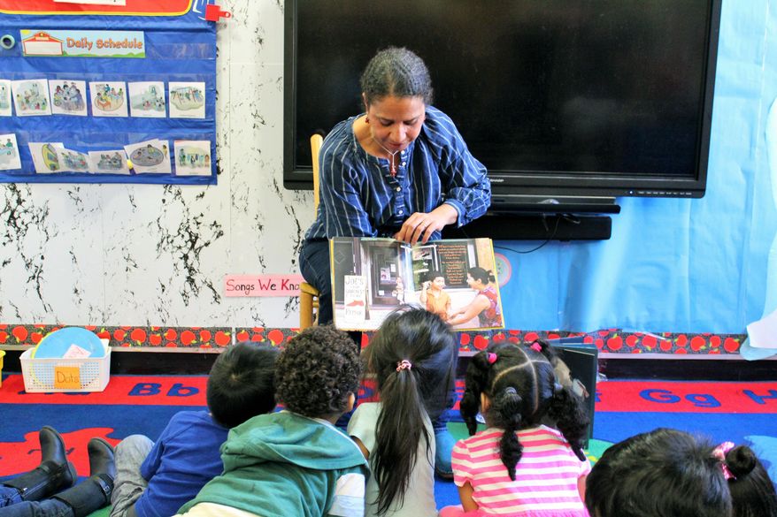 In this 2018 photo provided by Children&#x27;s Aid, Nina Crews, illustrator of &amp;quot;A Girl Like Me,&amp;quot; reads to children at an early childhood education center.  Crews said the work of independent publishers and grassroots organizers are vital in bringing more racial diversity into children&#x27;s books. (Adriana Alba/Children’s Aid via AP)