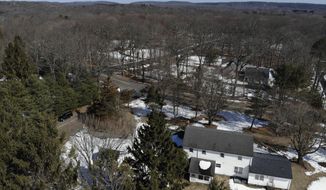 A five-bedroom house, bottom, is seen in Woodbridge, Conn., Wednesday, March 3, 2021. The home was recently sold and the owners want to raze the house to build a multi-family home. Zoning laws have been under scrutiny for years in Connecticut towns. But the issue has intensified recently, especially in Woodbridge, a New Haven County community of nearly 9,000 with a town center on the National Register of Historic Places. Tim Herbst, a former Republican candidate for governor, is representing a dozen residents opposed to changes proposed by the Open Communities Alliance, an organization founded in 2013 to improve access to affordable housing. (AP Photo/Seth Wenig)
