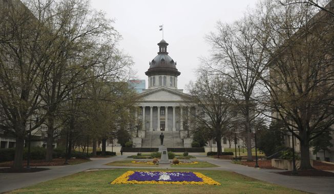 The South Carolina Statehouse and a flower bed designed as the state logo is seen on Tuesday, March 16, 2021, in Columbia, South Carolina. . (AP Photo/Jeffrey Collins)  **FILE**