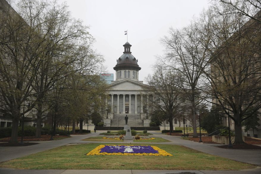 The South Carolina Statehouse and a flower bed designed as the state logo is seen on Tuesday, March 16, 2021, in Columbia, South Carolina. . (AP Photo/Jeffrey Collins) **FILE**