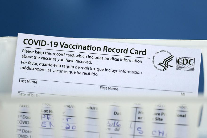 A vaccination record card is shown during a COVID-19 vaccination drive for Spring Branch Independent School District education workers Tuesday, March 16, 2021, in Houston. School employees who registered were given the Pfizer vaccine.(AP Photo/David J. Phillip)