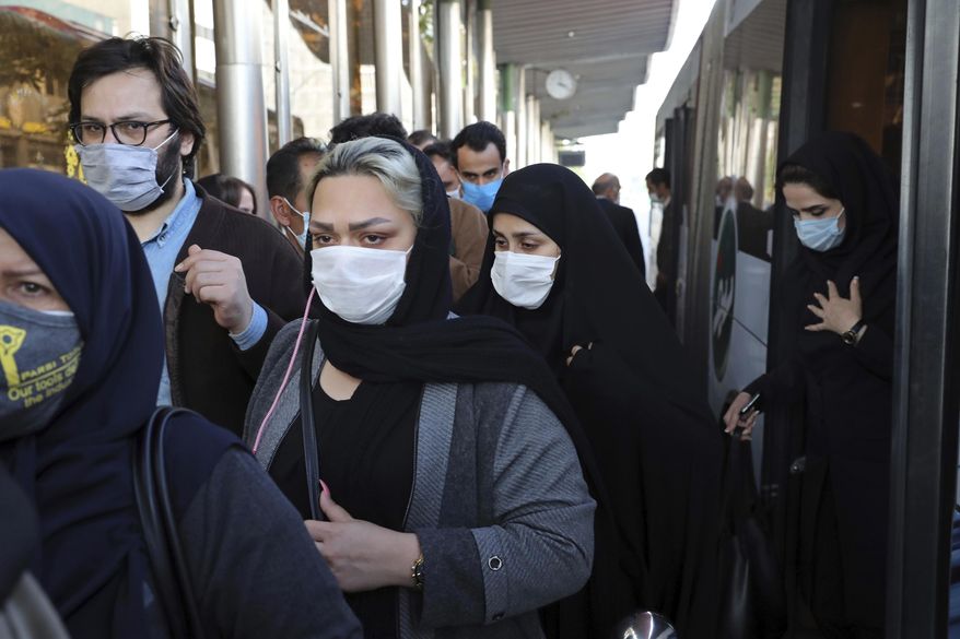 FILE - In this Oct. 11, 2020, file photo, people wear protective face masks to help prevent the spread of the coronavirus in downtown Tehran, Iran. Iran's campaign to inoculate its population against the coronavirus and promote itself as an emerging vaccine manufacturer inched on as health authorities announced Tuesday, March 16, 2021, that the country's third homegrown vaccine has reached the phase of clinical trials. (AP Photo/Ebrahim Noroozi, File)