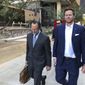 FILE - In this Nov. 5, 2019, file photo, then-Maricopa County Assessor Paul Petersen, right, and his attorney, Kurt Altman, leave a court hearing in Phoenix. Petersen is scheduled on Friday, March 19, 2021, to receive the second of three prison sentences for convictions stemming from his acknowledged operation of an illegal adoption scheme involving women from the Marshall Islands. (AP Photo/Jacques Billeaud, File)