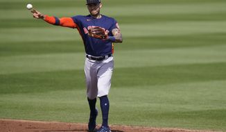 Houston Astros shortstop Carlos Correa throws Miami Marlins&#x27; Corey Dickerson out at first during the third inning of a spring training baseball game, Friday, March 5, 2021, in Jupiter, Fla. (AP Photo/Lynne Sladky)