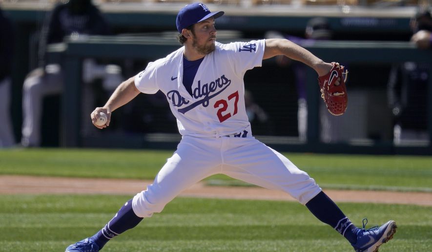 FILE - In this Monday, March 1, 2021, file photo, Los Angeles Dodgers starting pitcher Trevor Bauer throws against the Colorado Rockies during the first inning of a spring training baseball game in Phoenix. (AP Photo/Ross D. Franklin, File)