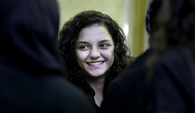 FILE - In this Aug. 30, 2014 file photo, Sanaa Seif, the younger daughter of Ahmed Seif, one of Egypt&#x27;s most prominent civil rights lawyer and campaigner, receives condolences for her father at Omar Makram Mosque after being temporarily released from prison, in Cairo, Egypt. An Egyptian court on Wednesday, March 17, 2021, convicted Seif, a prominent human rights activist, of spreading false news and insulting a police officer, sentencing her to 18 months in prison. (AP Photo/Amr Nabil, File)