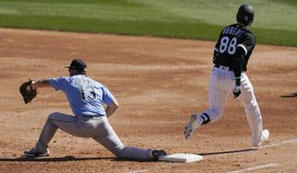 Chicago White Sox&#39;s Luis Robert (88) beats out an infield single as Seattle Mariners first baseman Sam Travis (13) makes a late catch during the third inning of a spring training baseball game Friday, March 5, 2021, in Phoenix. (AP Photo/Ross D. Franklin)