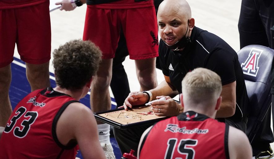 FILE - Eastern Washington head coach Shantay Legans talks to his players during the second half of an NCAA college basketball game against Arizona in Tucsin, Ariz., in this Saturday, Dec. 5, 2020, file photo. If some of the offensive and defensive schemes 14th-seeded Eastern Washington runs look awfully similar to the style of Kansas, that's because it is. Coach Shantay Legans has never formally met Jayhawks coach Bill Self, his counterpart in the first round, but feels like he knows Self given how much time he's studied Self's team and style. (AP Photo/Rick Scuteri, File)