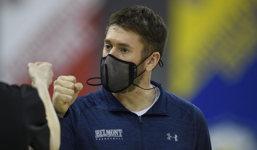 Belmont head coach Bart Brooks fist bumps an assistant after defeating UT-Martin in an NCAA college basketball game in the championship of the Ohio Valley Conference tournament at the Ford Center in Evansville, Ind., Saturday, March 6, 2021. (Sam Owens/Evansville Courier & Press via AP)