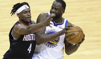 Golden State Warriors&#39; Draymond Green keeps the ball from Houston Rockets&#39; Danuel House Jr. during the first quarter of an NBA basketball game Wednesday, March 17, 2021, in Houston. (Carmen Mandato/Pool Photo via AP)