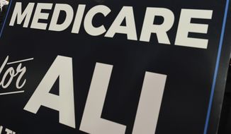 In this April 10, 2019 file photo, a sign is shown during a news conference to reintroduce &quot;Medicare for All&quot; legislation, on Capitol Hill in Washington. (AP Photo/Susan Walsh, file)