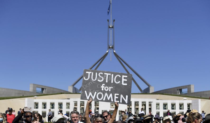 A protesters holds a placard during the Women's March 4 Justice in Canberra, Australia, Monday, March 15, 2021. The rally was one of several across Australia including in Sydney, Melbourne, Brisbane and Hobart calling out sexism, misogyny and dangerous workplace cultures. (Mick Tsikas/AAP Image via AP)
