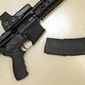 In this Oct. 3, 2013, file photo, a custom-made semi-automatic hunting rifle with a high-capacity detachable magazine is displayed at a gun store in Rocklin, Calif. California. (AP Photo/Rich Pedroncelli, File)