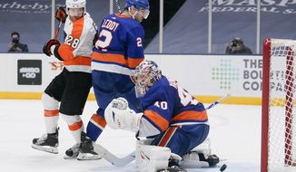 Philadelphia Flyers&#39; Claude Giroux (28) watches as the puck shot by Oskar Lindblom gets past New York Islanders&#39; Nick Leddy (2) and goaltender Semyon Varlamov (40) for a goal during the third period of an NHL hockey game Thursday, March 18, 2021, in Uniondale, N.Y.  (AP Photo/Frank Franklin II)