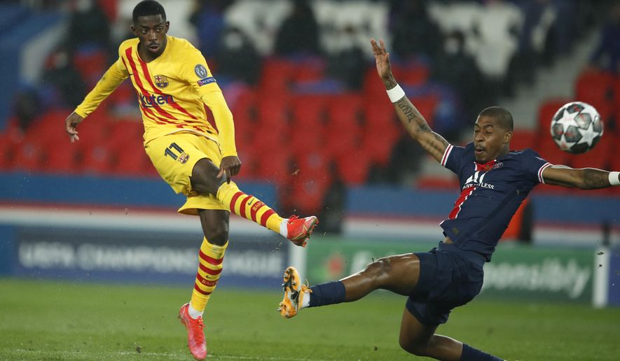Barcelona&#39;s Ousmane Dembele, left, attempts a shot at goal in front of PSG&#39;s Presnel Kimpembe during the Champions League, round of 16, second leg soccer match between Paris Saint-Germain and FC Barcelona at the Parc des Princes stadium in Paris, Wednesday, March 10, 2021. (AP Photo/Christophe Ena)