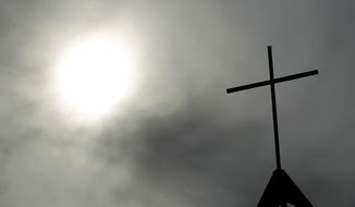 FILE - In this April 8, 2010 file photo a cross sits on top of a church in Berlin, Germany. A highly anticipated report commissioned by the Cologne archdiocese on church officials&#39; handling of past cases of sexual abuse by clergy is set to be released. (AP Photo/Markus Schreiber, File)