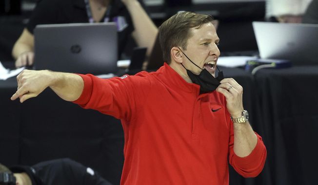 UNLV coach T.J. Otzelberger gestures during the second half of the team&#x27;s NCAA college basketball game against Air Force in the first round of the Mountain West Conference men&#x27;s tournament Wednesday, March 10, 2021, in Las Vegas. (AP Photo/Isaac Brekken)