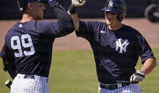 New York Yankees&#x27; DJ LeMahieu, right, celebrates with Aaron Judge after hitting a three-run home run off Pittsburgh Pirates pitcher JT Brubaker during the second inning of a spring training exhibition baseball game in Tampa, Fla., Saturday, March 13, 2021. (AP Photo/Gene J. Puskar