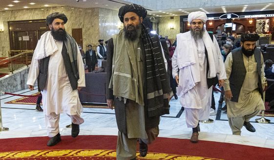 Taliban co-founder Mullah Abdul Ghani Baradar, center, arrives with other members of the Taliban delegation for an international peace conference in Moscow, Russia, Thursday, March 18, 2021. Russia is hosting a peace conference for Afghanistan, bringing together government representatives and their Taliban adversaries along with regional observers in a bid to help jump-start the country&#39;s stalled peace process. The one-day gathering Thursday is the first of three planned international conferences ahead of a May 1 deadline for the final withdrawal of U.S. and NATO troops from the country, a date fixed under a year-old agreement between the Trump administration and the Taliban. (AP Photo/Alexander Zemlianichenko, Pool)