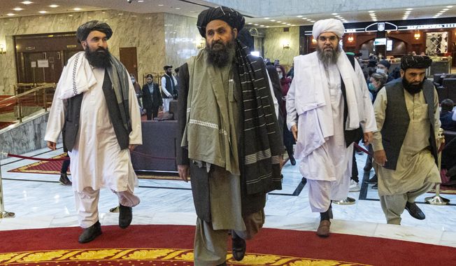 Taliban co-founder Mullah Abdul Ghani Baradar, center, arrives with other members of the Taliban delegation for an international peace conference in Moscow, Russia, Thursday, March 18, 2021. Russia is hosting a peace conference for Afghanistan, bringing together government representatives and their Taliban adversaries along with regional observers in a bid to help jump-start the country&#x27;s stalled peace process. The one-day gathering Thursday is the first of three planned international conferences ahead of a May 1 deadline for the final withdrawal of U.S. and NATO troops from the country, a date fixed under a year-old agreement between the Trump administration and the Taliban. (AP Photo/Alexander Zemlianichenko, Pool)