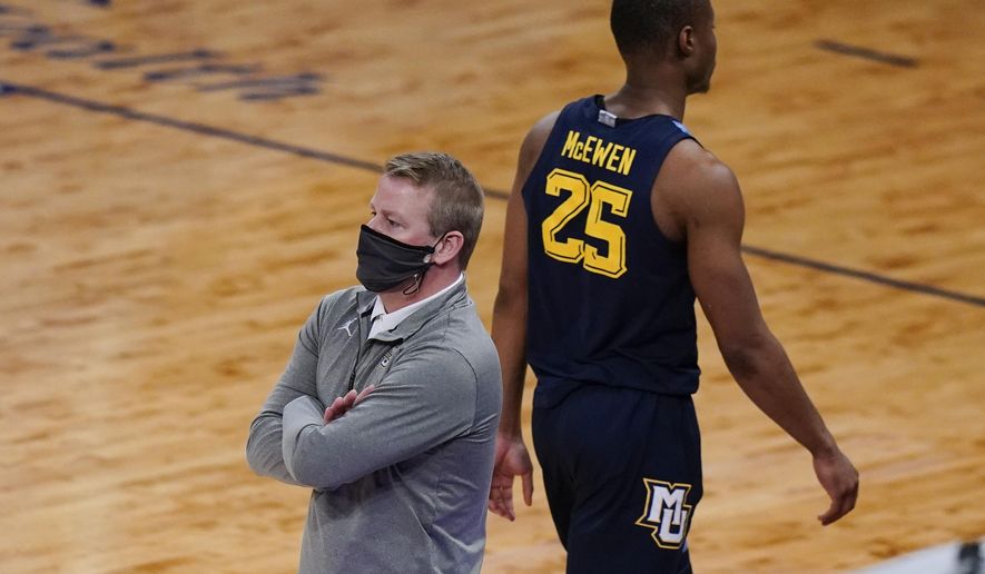 Marquette head coach Steve Wojciechowski, left watches his team play as Koby McEwen (25) heads to the bench after fouling out of the game during the second half of an NCAA college basketball game against Georgetown in the Big East conference tournament Wednesday, March 10, 2021, in New York. Georgetown won 68-49. (AP Photo/Frank Franklin II)